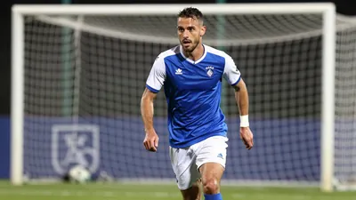 A photorealistic image of an anonymous FC Annecy midfielder, aged 25-30, with a lean build, in a blue jersey with white...