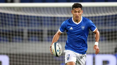 A photorealistic image of a Rodez player in a blue jersey with white shorts, running with the ball towards the goal, with...