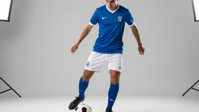 A photorealistic image of a 23-year-old Rodez player, wearing a blue jersey with white sleeves and a white pair of...