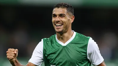 A photorealistic image of an anonymous Rodez player, aged 25-30, wearing a green and white jersey, with a white collar...